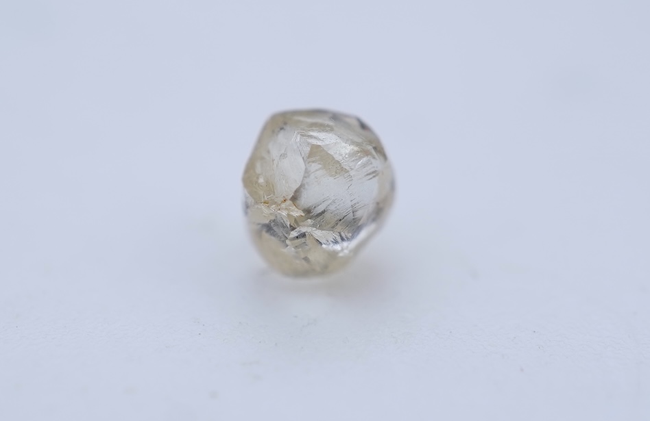 A rough diamond, with accompanying box and note, late 19th century